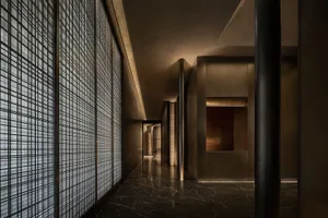 Empty hallway with a black marble floor and wood paneling walls, creating a calm and quiet atmosphere