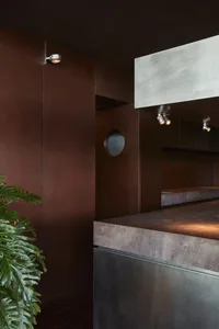 Kitchen with two sinks, brown walls, and a marble countertop, creating a warm and inviting atmosphere