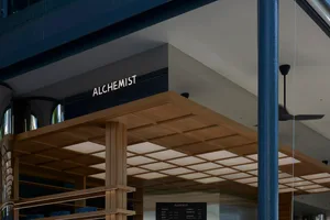 A storefront with a wooden exterior, showcasing books in the window and inviting atmosphere