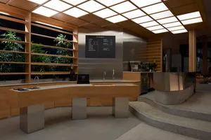 現代餐廳櫃檯配有兩個水槽與菜單看板，周圍環繞盆栽植物，空間整潔有序