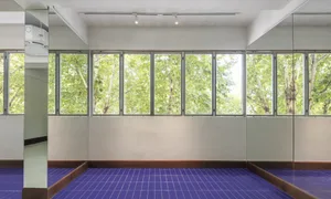 A bright and airy lobby with white walls, large windows, and natural light pouring in