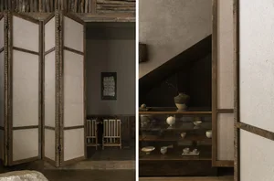 Cozy living space with a dining area, wooden door, and staircase, featuring a glass table, wooden accents, and comfortable seating