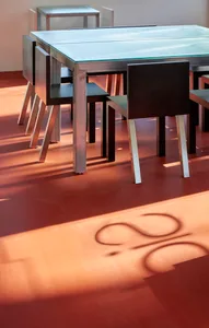 A dining area with a long metal table surrounded by chairs, creating a comfortable seating arrangement for gatherings and meals