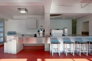 Industrial kitchen with stainless steel surfaces, modern appliances, and a clean, well-organized atmosphere