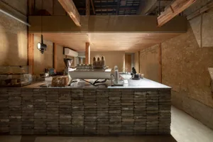 Industrial kitchen with a stone countertop, appliances, and organized layout
