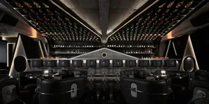Elegant wine bar with wooden accents, wine bottles, and comfortable seating