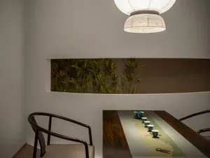 A cozy dining space with a wooden table and chairs, featuring a warm and inviting atmosphere