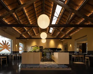 Warm and inviting restaurant interior with wooden floors and ceiling, featuring dining tables and chairs