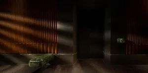 Dark hallway with wood panelled walls, two doors, and low lighting