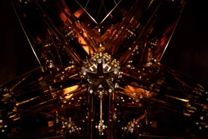 Intricate metal sculpture with organic shapes and patterns, converging lines creating a focal point
