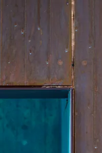 Old wooden wall with weathered planks, rust stains, and visible nails