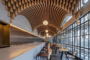 Warm and inviting restaurant interior with wooden tables and chairs, suitable for events or gatherings