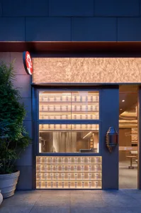 Modern Asian restaurant interior with natural light, seating areas, and decorative cups on the windowsill
