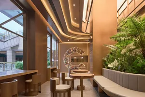 Warm and inviting cafe interior with wooden tables and chairs, ample seating for guests