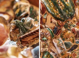 A ceramic art piece with intricate designs and patterns in earthy tones, displayed under artificial lighting