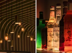 A casual bar area with bottles of alcohol on display, arranged in an organized manner on a shelf or countertop