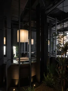 A restaurant interior with multiple chairs and dining tables, creating a comfortable and inviting atmosphere