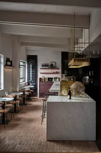 elegant restaurant interior with a marble bar, wine glasses, and wine bottles displayed in a modern and stylish environment