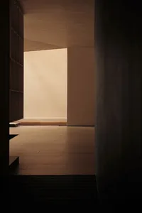 Empty room with wooden floor and white walls, providing a clean and minimalist space