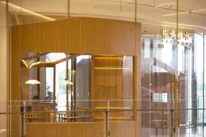 Warm and inviting restaurant interior with wooden walls and floors, featuring chairs and a cozy atmosphere