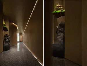 Asian-inspired interior design with Chinese artwork, a rock garden, and a combination of living and dining areas with chairs and a potted plant