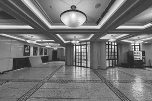 A large, empty lobby with high ceilings, a marble floor, and plenty of natural light