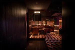 Cozy restaurant interior with black and white theme, wood and metal elements, and modern design