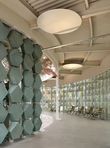 A spacious lobby with multiple chairs and dining tables, creating a comfortable and social atmosphere for guests