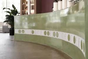 Modern interior design concept featuring a curved green wall with decorative elements and scattered bottles, creating a unique and stylish atmosphere