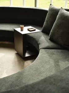 Cozy living space with two couches, a coffee table, and a cup of coffee on a small table between them