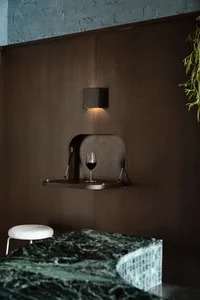 Cozy dining room with dark wood paneling, a dining table, and two chairs, designed for relaxation and socializing