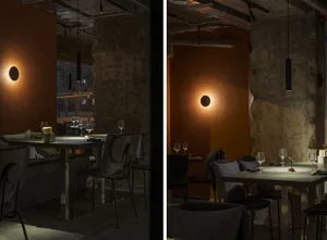 Dimly lit restaurant interior with modern furniture, clean lines, and minimalistic design elements, featuring wine glasses and tables