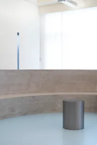 Empty minimalist room with a concrete bench in the center, featuring a simple, functional space with no decorative elements or additional features