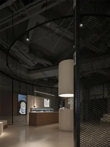 A commercial space with a white counter and seating areas, featuring bottles and cups on display, in a clean and well-organized atmosphere