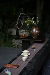 A calm and inviting dining space with a wooden table, vases, and a bowl, creating a warm atmosphere