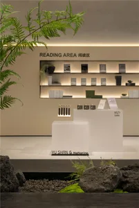 A well-lit interior design store showcasing various books on display on different surfaces, creating an inviting atmosphere for customers to explore