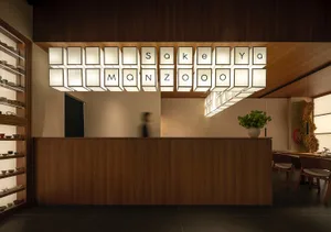 Warm and inviting restaurant interior with a wooden countertop, letters on the wall, and two people in the scene