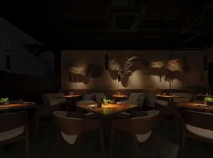An empty restaurant with wooden tables and chairs in various styles and sizes, creating a welcoming atmosphere for dining