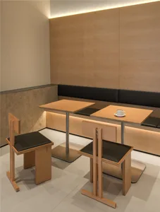 Warm and inviting restaurant interior with wooden tables and chairs, featuring a table with a cup, creating a cozy atmosphere