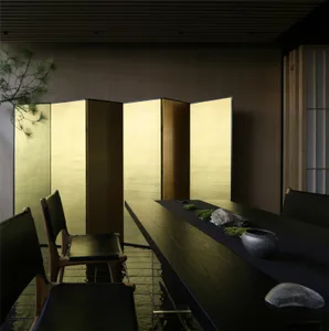 Sophisticated dining area with a long wooden table, black surface, and potted plants
