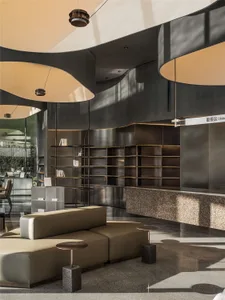 Cozy living area with a large couch, bookshelf, and comfortable seating arrangement