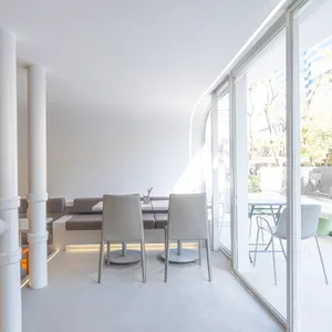 Open dining area with a modern table and metal chairs, a couch, and ample seating options