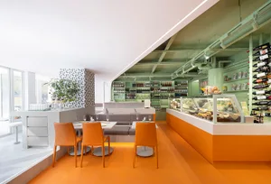 Warm and inviting dining area with a large wooden table and chairs, surrounded by wine glasses and a cozy atmosphere