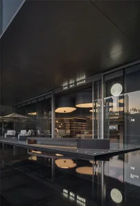 A modern interior design showroom with glass walls, various chairs, and couches, creating a comfortable and inviting atmosphere