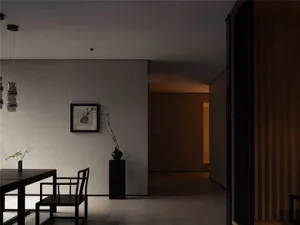 Empty modern living room with a dining table, two chairs, white walls, and a black vase