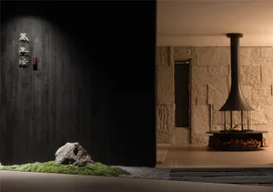 Dark and moody living space with two large rocks, a black doorway, and dim lighting