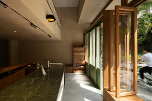 A warm and inviting kitchen with a bookshelf, sink, and doorway to the outdoors