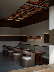 Warm and inviting restaurant interior with brown wooden walls and tables, featuring chairs and a cozy atmosphere