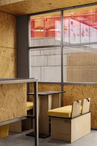 A cozy restaurant dining area with wooden tables and chairs, featuring multiple tables with chairs and an inviting atmosphere