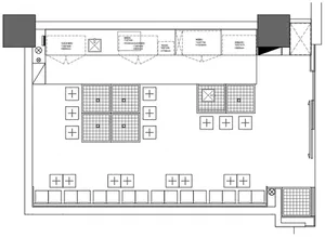 Black and white floor plan of a restaurant space with multiple dining tables, chairs, and benches arranged in a functional and well-organized layout